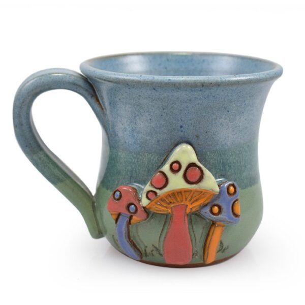 Blue-green stoneware mug with colorful raised mushrooms.