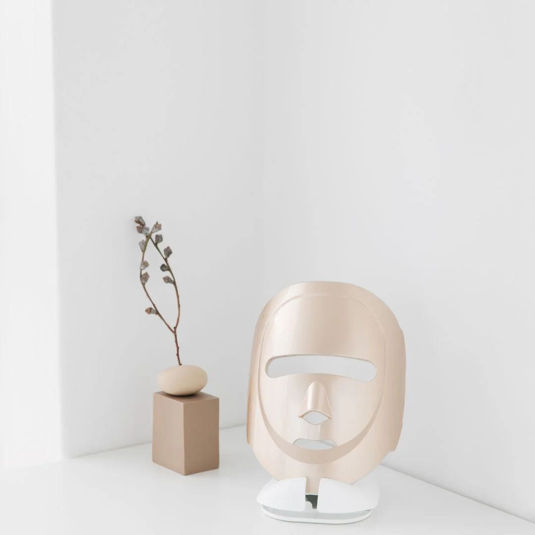 Eco Face Platinum LED Mask in gold shown with a companion eye-care device