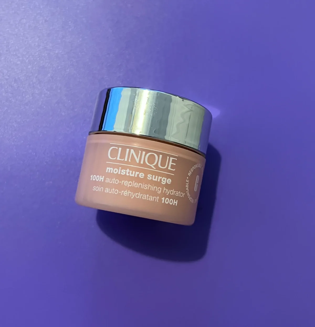 Clinique Moisture Surge 100H gel-cream jar on a purple background