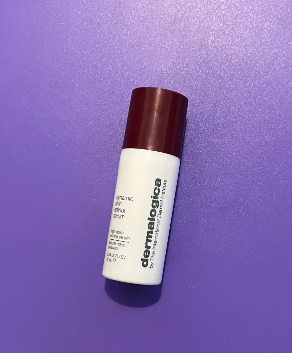 Dermalogica Dynamic Skin Retinol Serum mini bottle on a purple background