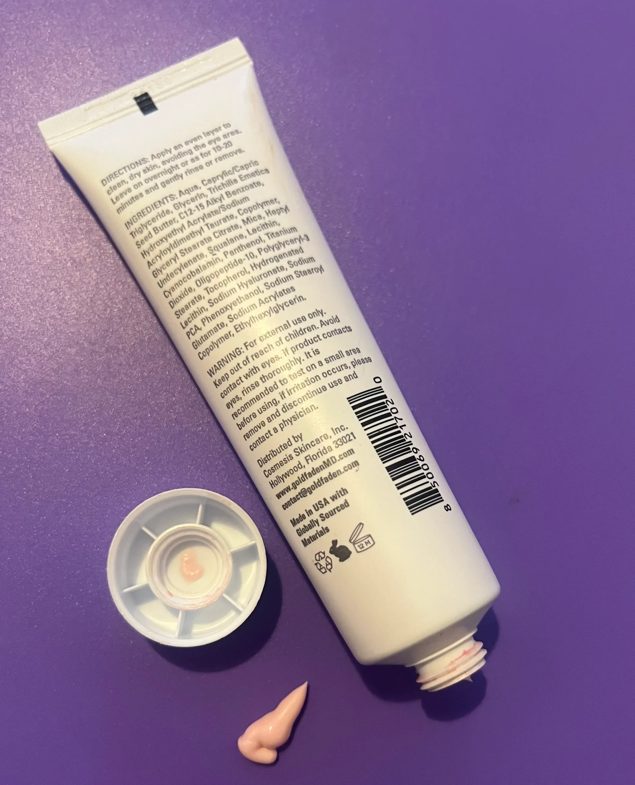 Open Goldfaden MD Radiance Whip tube with light-pink mask texture on a purple background