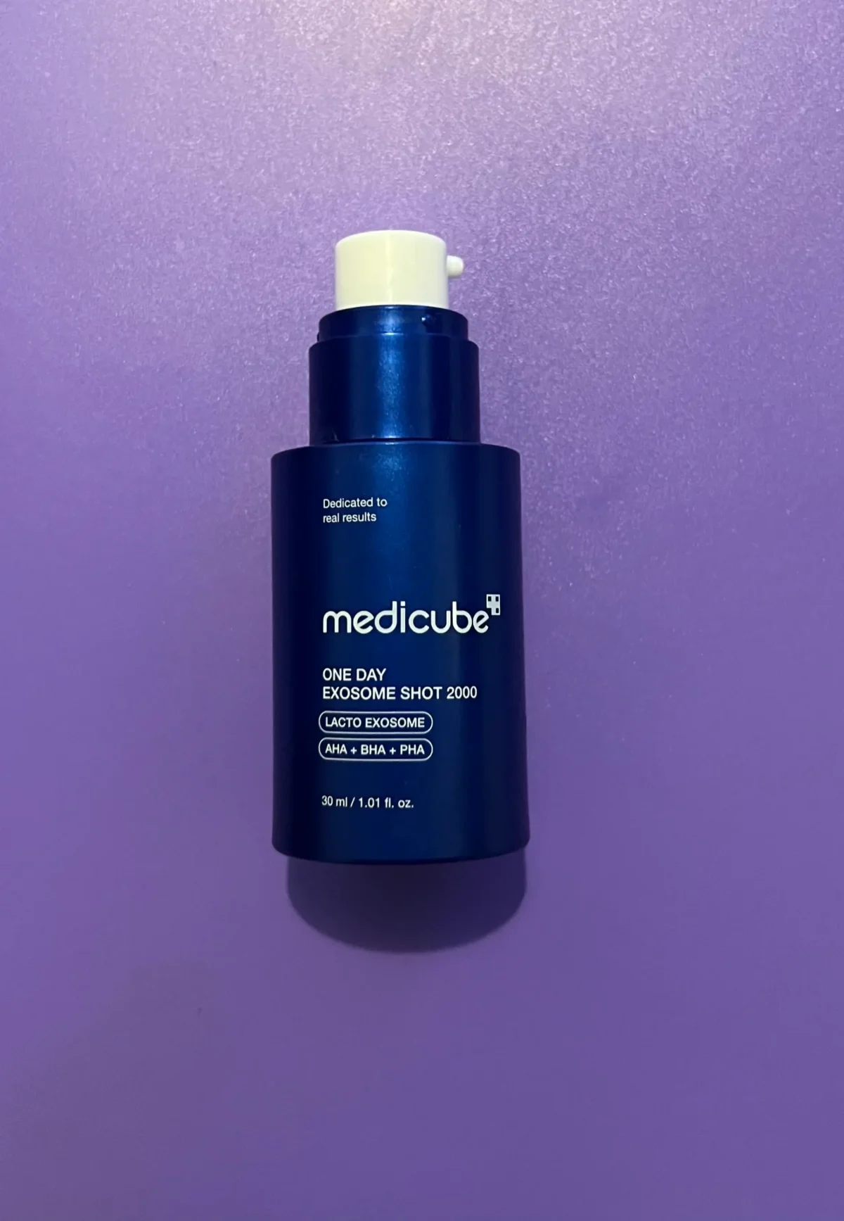Medicube One Day Exosome Shot 2000 bottle photographed on a purple background