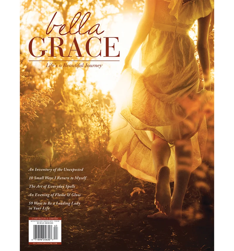 Bella Grace Issue 49 cover with a woman walking through a sunlit garden.