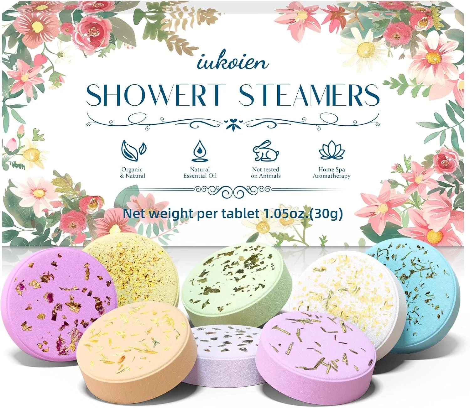 Eight colorful shower steamer tablets beside an iukoien floral gift box.