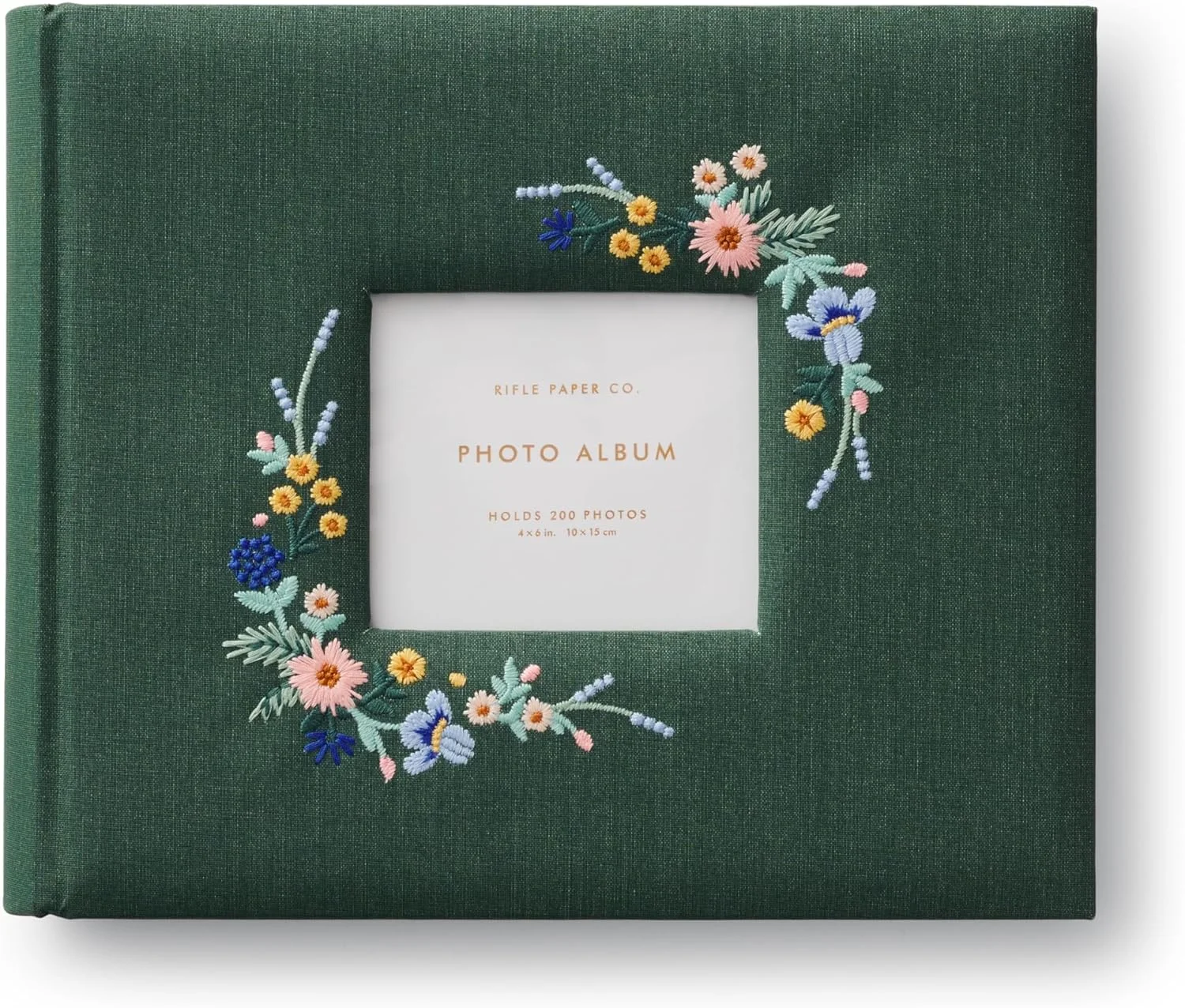 Dark green Wildwood photo album with embroidered flowers around a cover window.
