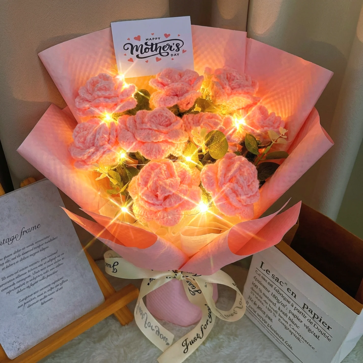 Pink crochet rose bouquet with string lights and a Happy Mother’s Day sign.