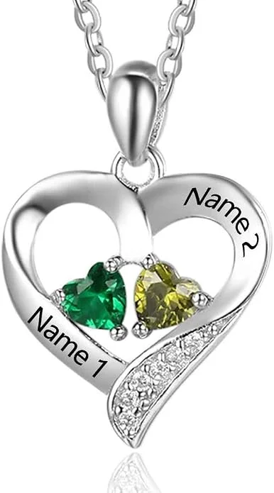 Silver-colored heart pendant with two name engravings and green and yellow stones.