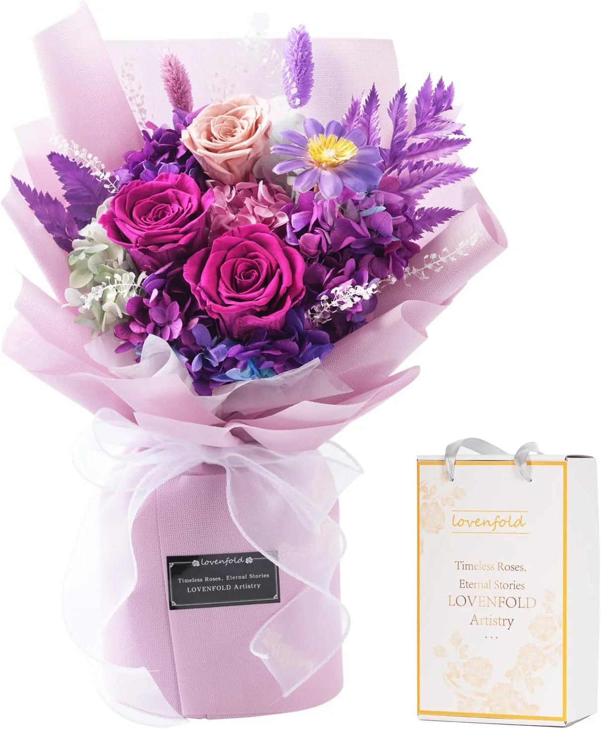 Purple and pink preserved flower bouquet in pale pink wrapping beside a Lovenfold gift bag.